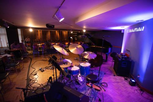 a room with drums and a stage with purple lights at The Charles Hotel in Harvard Square in Cambridge
