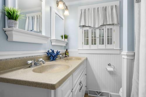 a bathroom with two sinks and a mirror at 19 Burton Avenue West Harwich - - Lobsta House in West Harwich
