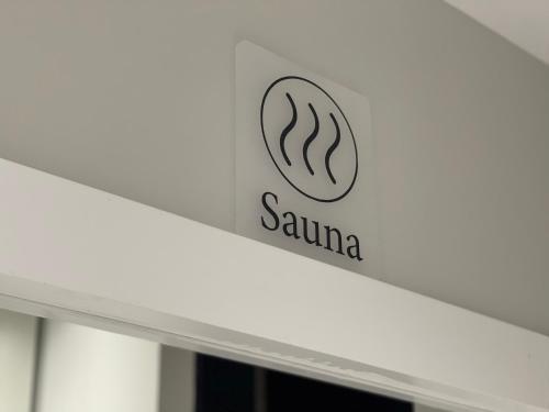 a sign for a sarmaarmaarmaarmaarmaarmaarmaarmaarma at Ambassador Skyline Apartments in Tirana
