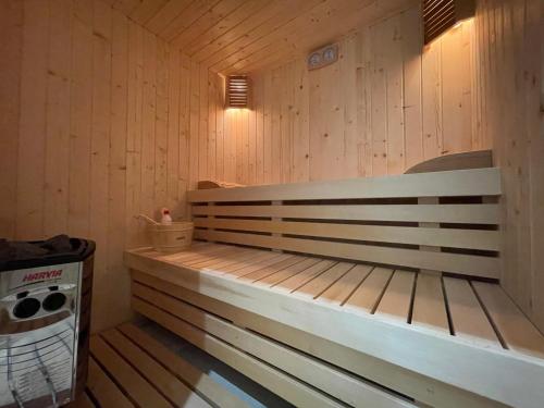 a sauna with a bench and a trash can at Ambassador Skyline Apartments in Tirana
