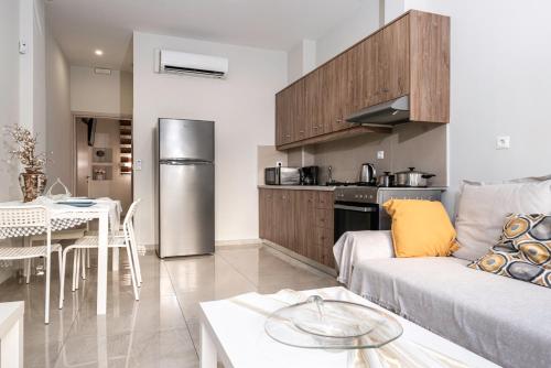 a living room with a couch and a kitchen at NEON Apartment, modern, high quality, central Apt, Heraklion City in Heraklio