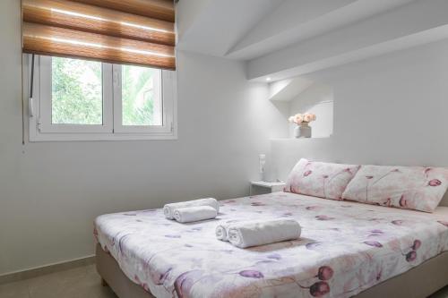 a bedroom with a bed with two pillows on it at NEON Apartment, modern, high quality, central Apt, Heraklion City in Heraklio