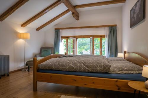 een slaapkamer met een houten bed en een raam bij Chalet Elza in Lauterbrunnen