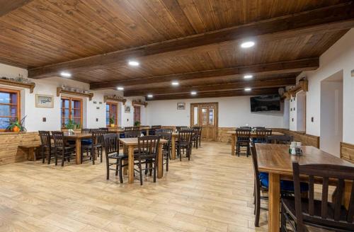 a dining room with wooden tables and chairs at Horská bouda Krakonoš in Pec pod Sněžkou