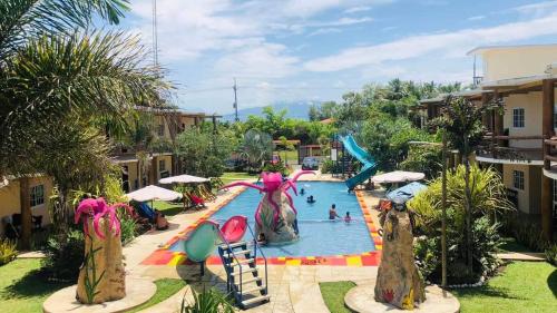 a pool at a resort with people playing in it at Hotel Pazifico en Monterrico in Monterrico