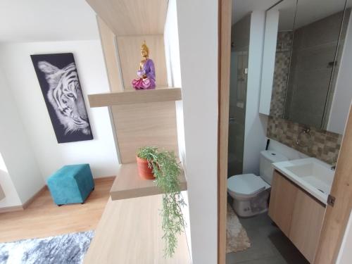 uma casa de banho com um lavatório e um WC num quarto em Elegante Refugio en las alturas em Bogotá
