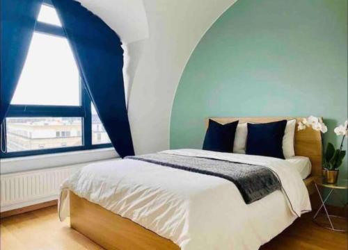 a bedroom with a bed with a large window at Penthouse 2 bedrooms With Terrace & Free Parking in Luxembourg