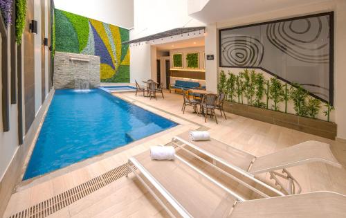 a swimming pool in the middle of a house at REEC Machala by Oro Verde Hotels in Machala