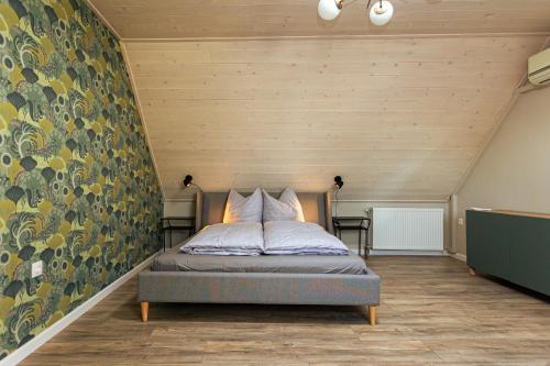 a bedroom with a bed in a room with wooden walls at ESTER'S Szentbékkálla in Szentbékkálla