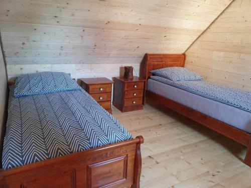 A bed or beds in a room at Sloneczna Osada 2