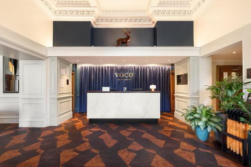 a view of a lobby with a vola reception desk at voco Edinburgh - Royal Terrace by IHG in Edinburgh