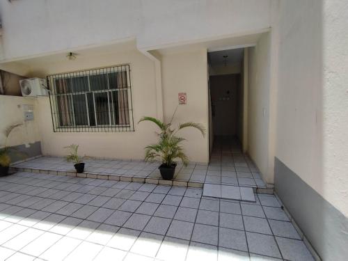 a room with two potted plants in a building at Seu Apto na Praia da Costa 3 Todo seu Completo Ar Cond Fogão Geladeira Internet Local Excelente Centro Sem escadas in Vila Velha