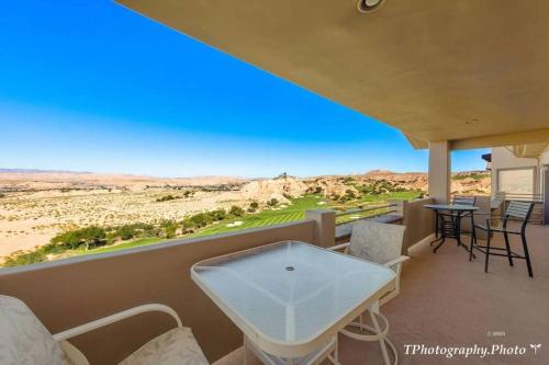 a balcony with a table and chairs and a view of the desert at Golfers Getaway - Mesquite in Mesquite