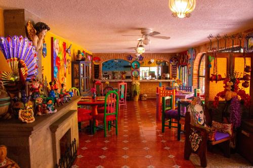 a room filled with lots of colorful chairs and tables at Posada las Margaritas in Guadalajara
