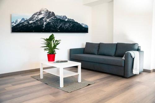 a living room with a couch and a table at Appartamento Laurel in Tenna 