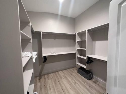 a room with gray and white closets with wooden floors at 4BR Oasis - Pool and Spa - Near Golf and Casinos in Mesquite