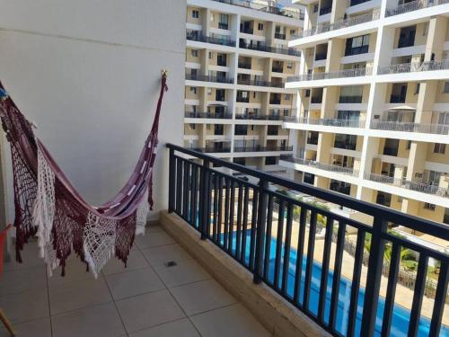 a balcony with a hammock in front of a building at Apart hotel Tagualife in Riacho Fundo
