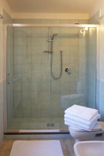 a bathroom with a shower with a toilet and a sink at Villa Elisa in Agerola