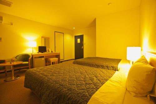 a hotel room with two beds and a desk at HOTEL SEAGULL - Vacation STAY 86778v in Izumi-Sano