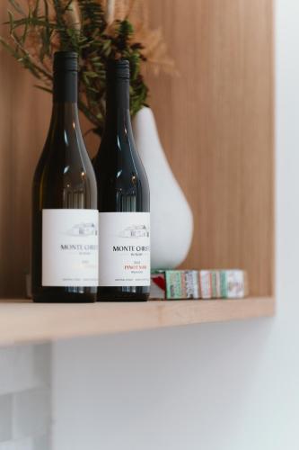 two bottles of wine sitting on a shelf at Monte Christo Winery Cottages in Clyde