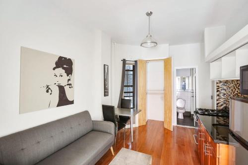 uma sala de estar com um sofá e uma mesa em Apartment 799: Hells Kitchen em Nova York