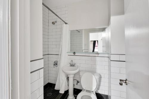 uma casa de banho branca com um WC e um lavatório em Apartment 799: Hells Kitchen em Nova York