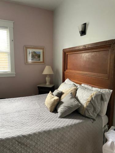 a bedroom with a large bed with pillows on it at 150-year-old Lincolnville cottage 3bedroom 2bath in St. Augustine