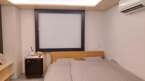 Säng eller sängar i ett rum på Kimura Building - Vacation STAY 15558
