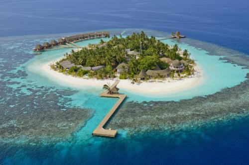 an island in the ocean with a resort on it at Kandolhu Maldives in Himandhoo 