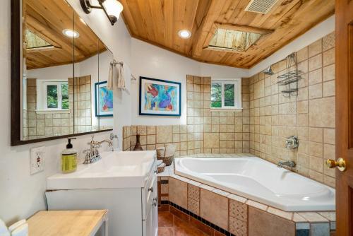 a bathroom with a tub and a sink at Secret Garden MCA#1504 in Manzanita