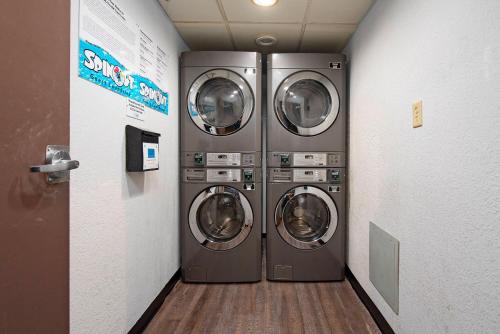 two washing machines in a laundry room with a hallway at Apartment in Florida near Universal and Intern. Dr in Orlando