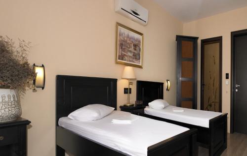 two beds in a room with white sheets at Vila Caviar in Sulina