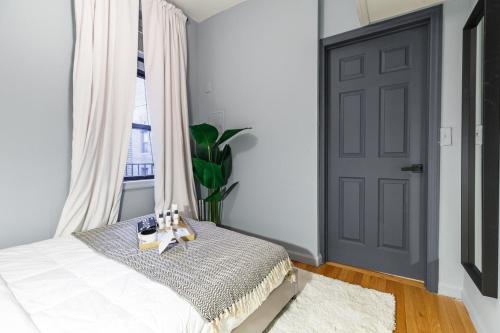 a bedroom with a bed and a window and a door at Apartment 282: Columbus Circle in New York