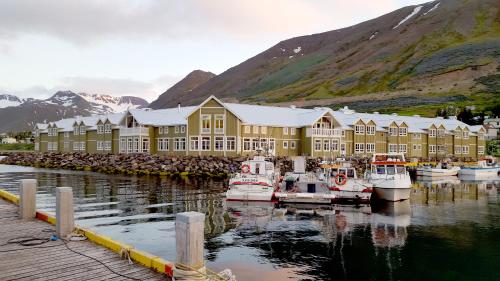 a large building with boats docked in a harbor at Siglo Hotel by Keahotels in Siglufjörður