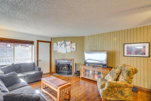 a living room with a couch and a tv at Brian Head Ski Condo - Walk to Giant Steps Lift! in Brian Head