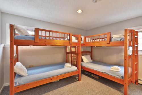 a room with three bunk beds in a house at Beautifully decorated 3 bedroom condo nestled Slopeside on Pico Mountain Ski-in Ski-out G101 in Killington