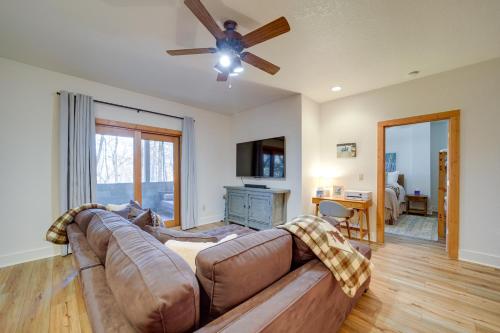 a living room with a couch and a ceiling fan at Sapphire Vacation Rental Less Than 1 Mi to Whisper Lake! in Sapphire