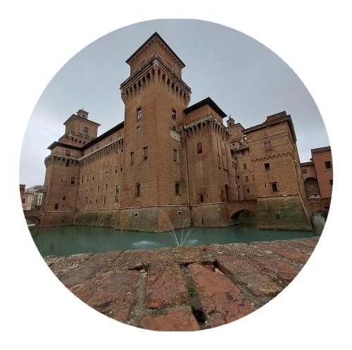 a large brick building with water in front of it at Giulio D'Este in Ferrara