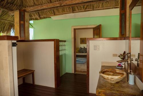 a bathroom with a sink in a room at Little Harvest Caye - Your Own Private Island in Placencia Village