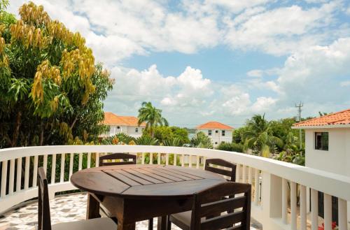 a wooden table on the balcony of a house at 3 Story Oceanfront Luxury Villa 5 Bedroom w Pool in Maya Beach