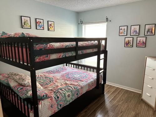 a bedroom with two bunk beds and a window at Lovely Home in Southern Dunes Golf & Country Club Gated Community in Haines City