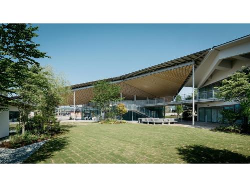 a large building with a lawn in front of it at ITOMACHI HOTEL 0 - Vacation STAY 97739v in Saijo