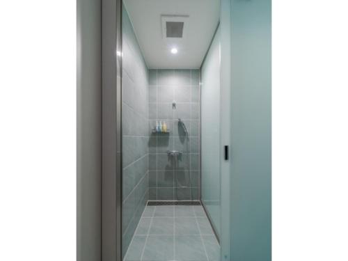 a bathroom with a shower with a glass door at ITOMACHI HOTEL 0 - Vacation STAY 97646v in Saijo