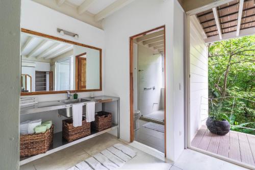a bathroom with a sink and a mirror at Casa Pochote in Santa Teresa Beach