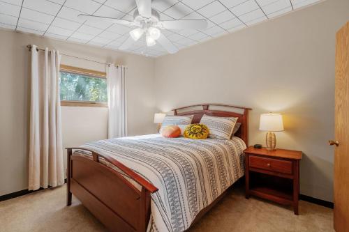 a bedroom with a bed and a ceiling fan at Lake Pulaski Getaway in Buffalo