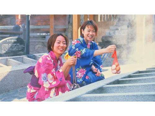 two women in kimonos sitting on steps holding a carrot at Asanoya - Vacation STAY 01715v in Shinonsen