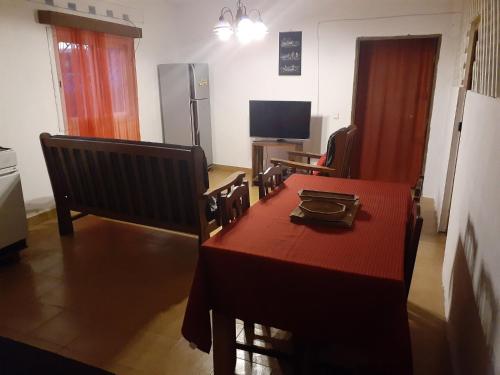 a dining room with a table and a television at Villa CALLI in Sambava
