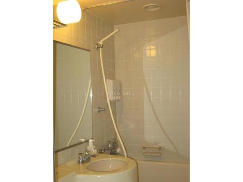 a bathroom with a sink and a tub and a mirror at Onomichi Daiichi Hotel - Vacation STAY 02586v in Onomichi