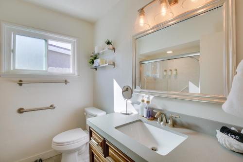 a bathroom with a sink and a mirror and a toilet at San Diego Home Private Outdoor Pool and Game Room! in San Diego