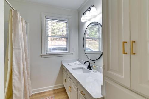 a white bathroom with a sink and a mirror at Centrally Located Home about Steps to Oxford Square! in Oxford
